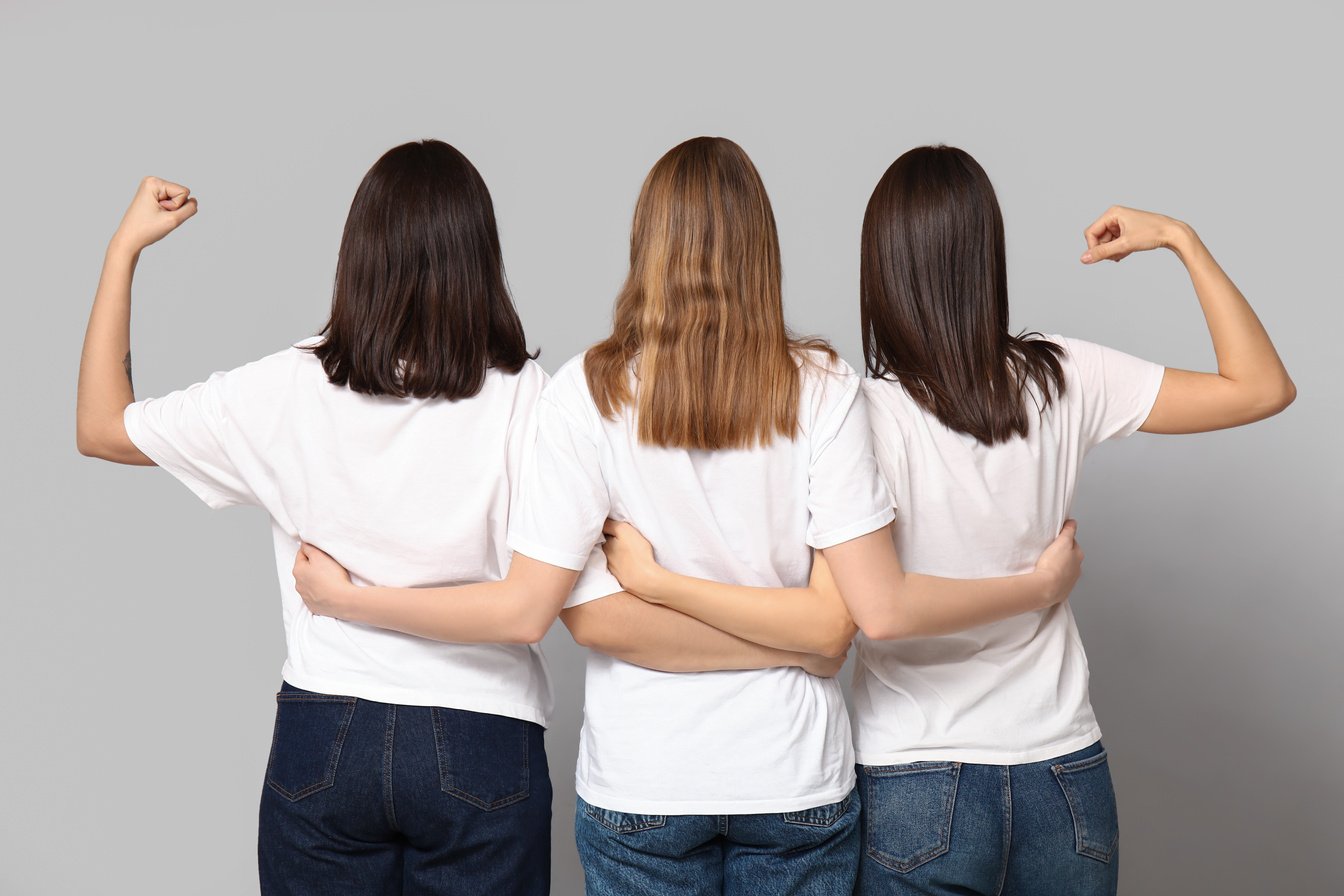 Hugging Women on Grey Background, Back View. Women History Month